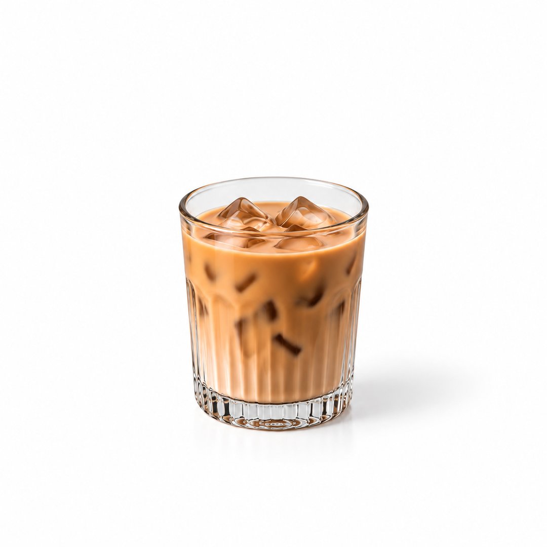 Iced masala chai in a tall glass with a straw